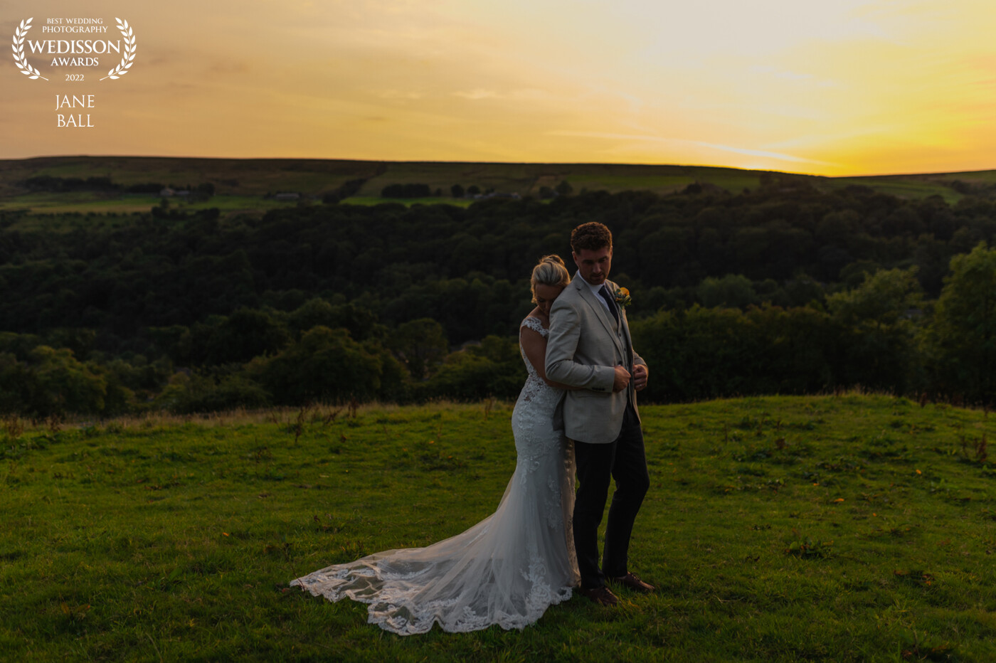 Alex and Nathan's wedding took place at their own home, a stunningly beautiful property in the heart of East Lancashire. They knew exactly how they wanted their romantic portraits to look so they chose the place that has the best views of the sunset and boy it didn't disappoint! There were so many gorgeous images of them it was really hard to choose which one to submit. In the end I chose this one because of how the setting sun caught the hem of Alex's dress, picking out the embellishments and making them shine like tiny diamonds.