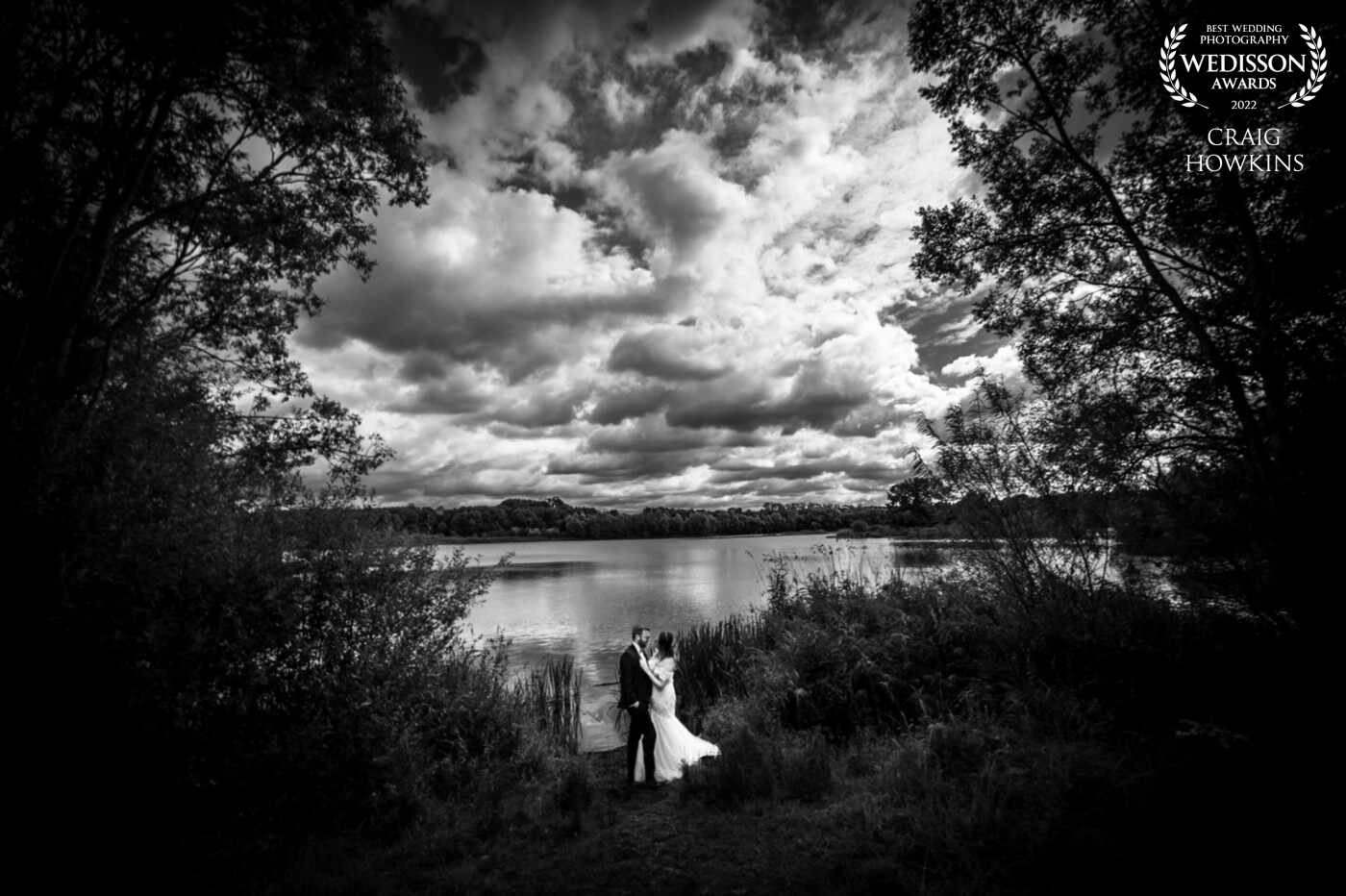 I love this shot! This image was taken at Stanwick Lakes in Northamptonshire. I love it when I can have so much creative fun with my clients. We had the perfect sky and with the trees framing the couple. I just put a wide angle 14mm lens on and we got this epic shot!