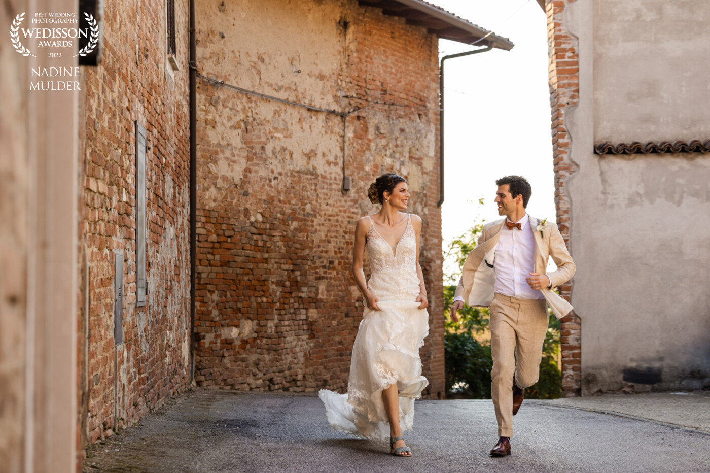 This was my first destination wedding! I was joining IVI Fotografie on a wedding organised by The Italian Wedding. I’ve been to Italy many times but never in the north and it’s nature blew me away! It was an honour for me to capture this beautiful couple during there amazing wedding and I had so much fun! This picture was taken in a very old small town and I just had the idea to let them run in the middle of this street.