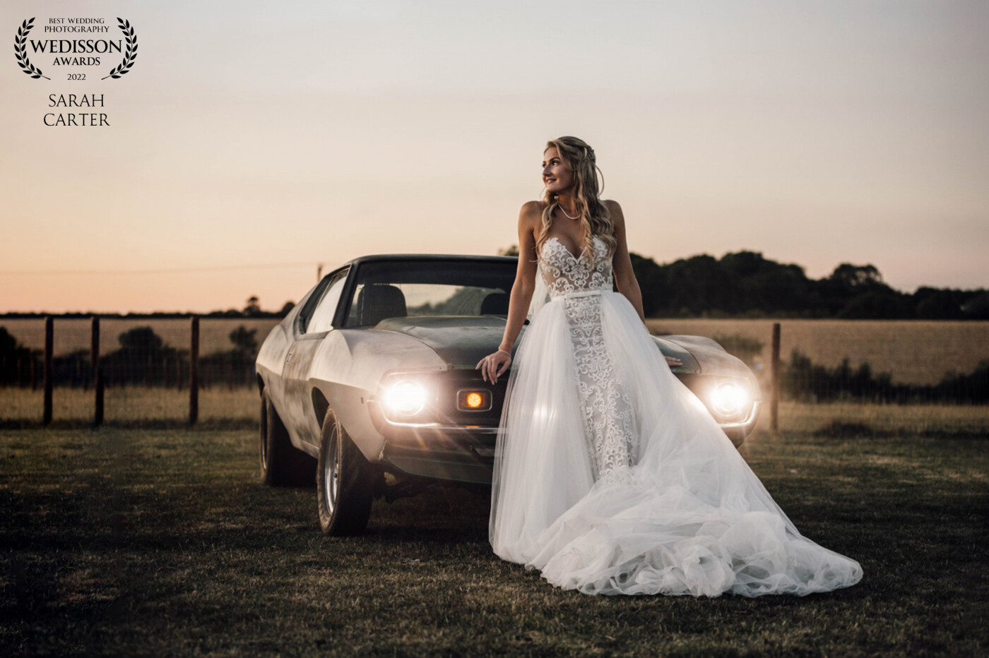 Took this just as the sun was going down. The wedding was in in a big field full of vintage cars. This beautiful bride is resting on her Husbands car. He has since told me he has this photo blown up in his garage. His two favourite things!