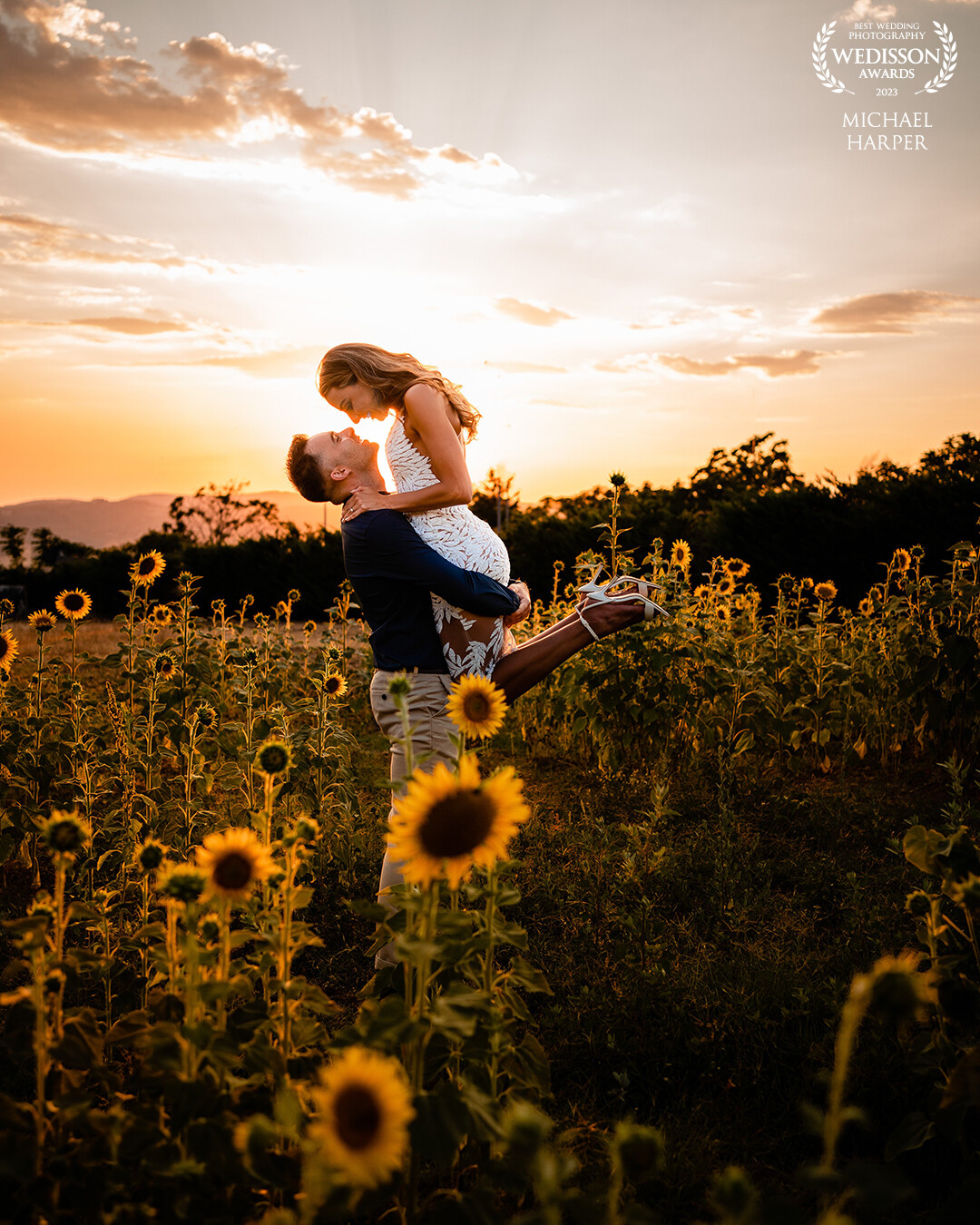In the rolling hills of Tuscany the day before the wedding, we found a patch of sunflowers which was the perfect end to the pre-wedding shoot. As the sunset, the groom lifted the bride-to-be in the air and created this moment.
