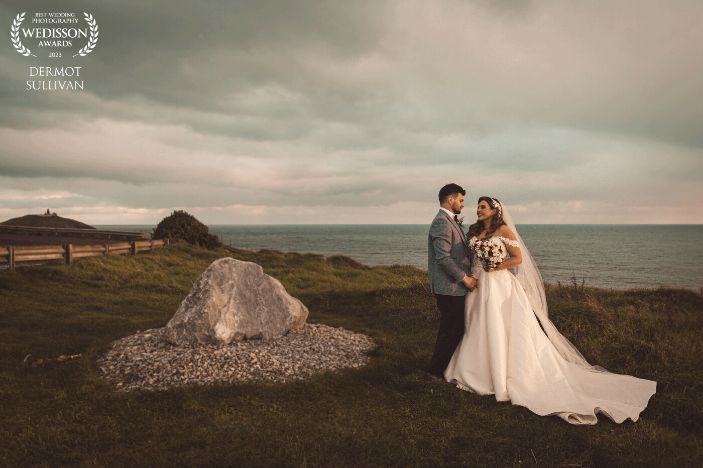 This amazing couple were really into creating great photographs using the seascape of Cork as the background. We went to a clifftop outside the village of Ballycotton  and climbed over some obstacles to get to our location. Their wedding was in early December, so the sun was setting around 4pm, which gave us the beautiful light. I shot it without flash or any additional lighting and edited it in Lr.