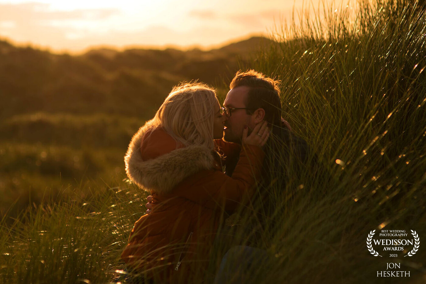 This was taken at Talacre Beach, North Wales, at sunset. The way the light bounced off the reeds and the intimacy between my couple gave such a beautiful moment to capture.