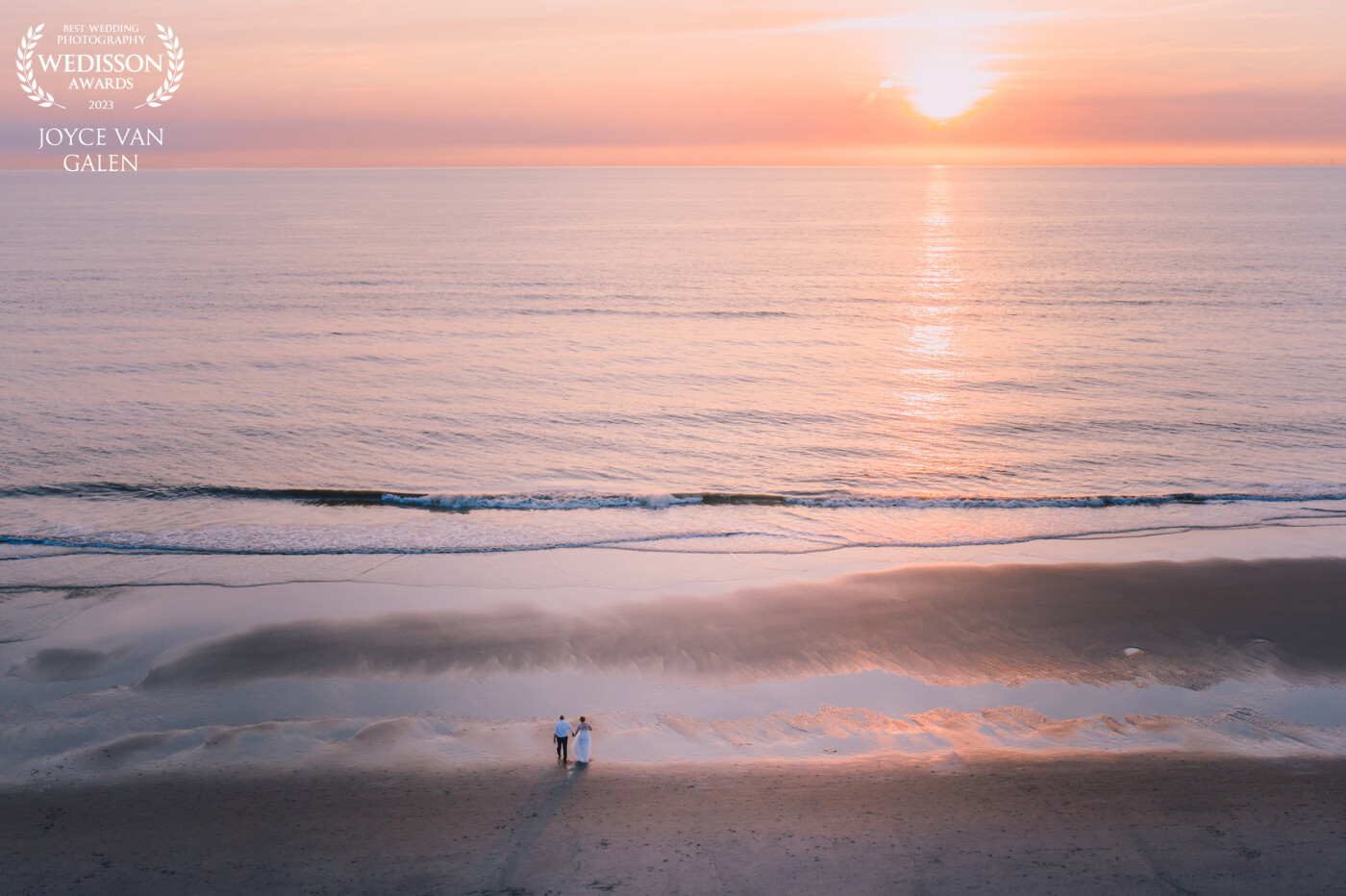 Always count me in for a photoshoot at sunset. The orange, pink, purple hues are so magical. This image is taken with a drone and with the wedding couple on the beach... no words!