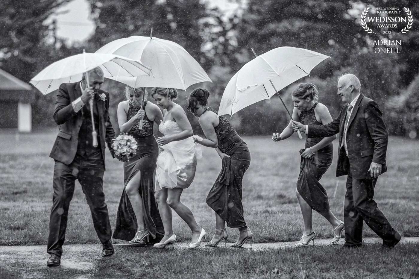 One of my faves!!! captured this image in the pouring rain. The bridal party were making a quick dash to the church...the were umbrellas flying all over the place!!! this is a side to my wedding photography that I don't usually show, but the moment was too good not to share.