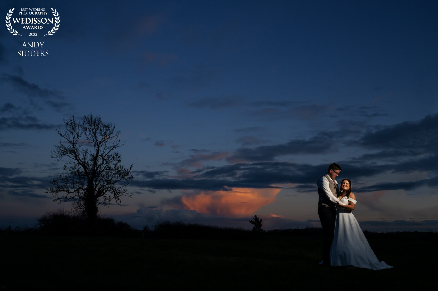 This photo was taken at Jess and Matt's wedding at Hunstmill Farm. There was a moody looking sunset, so I positioned the couple and then lit them with off camera flash.