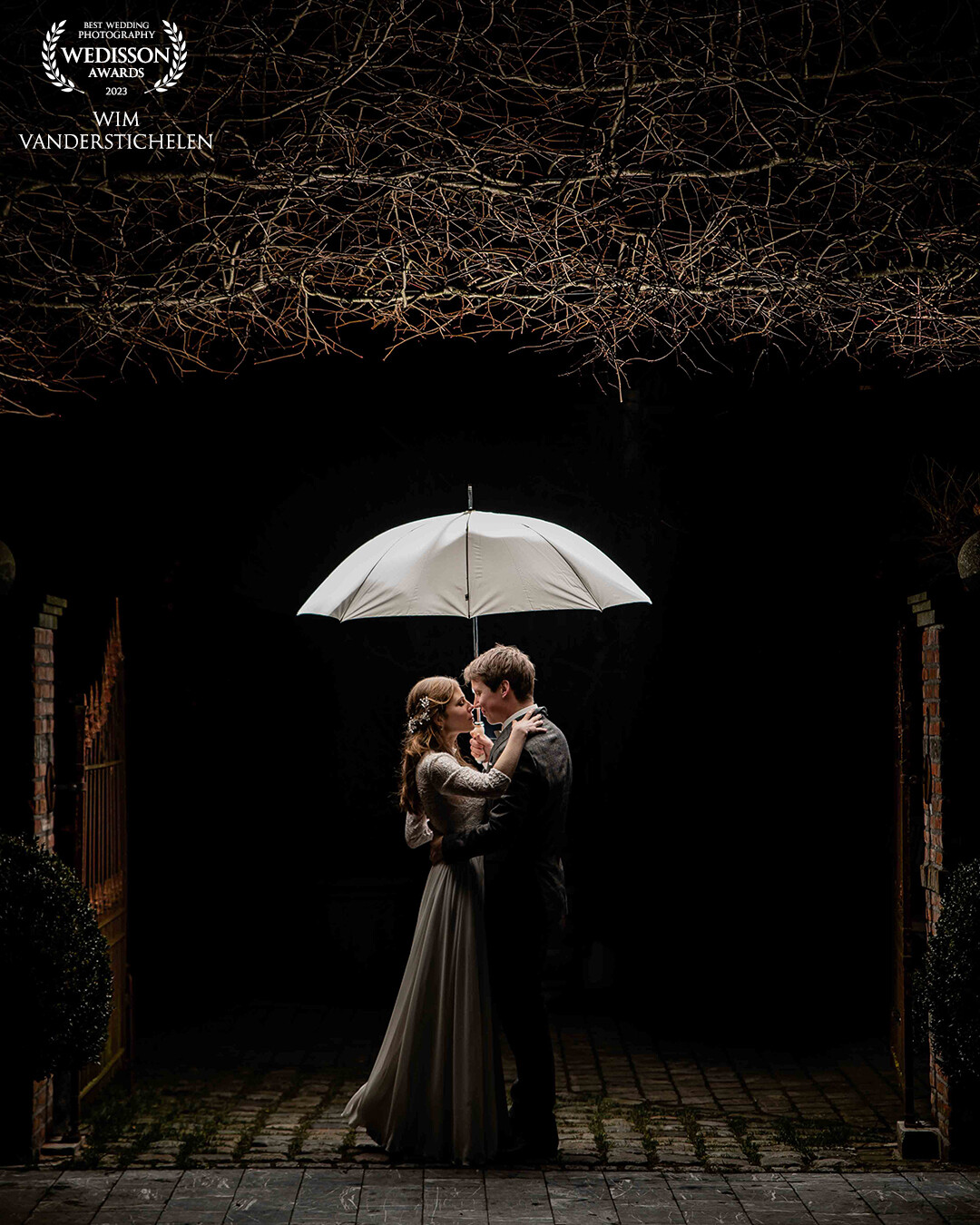 This couple had a white umbrella ready for the rain on their big day. That day was a very sunny day in january, but I allready knew that I was going to get a great picture with it at night. For this result I used a flash bouncing up the light in the umbrella.