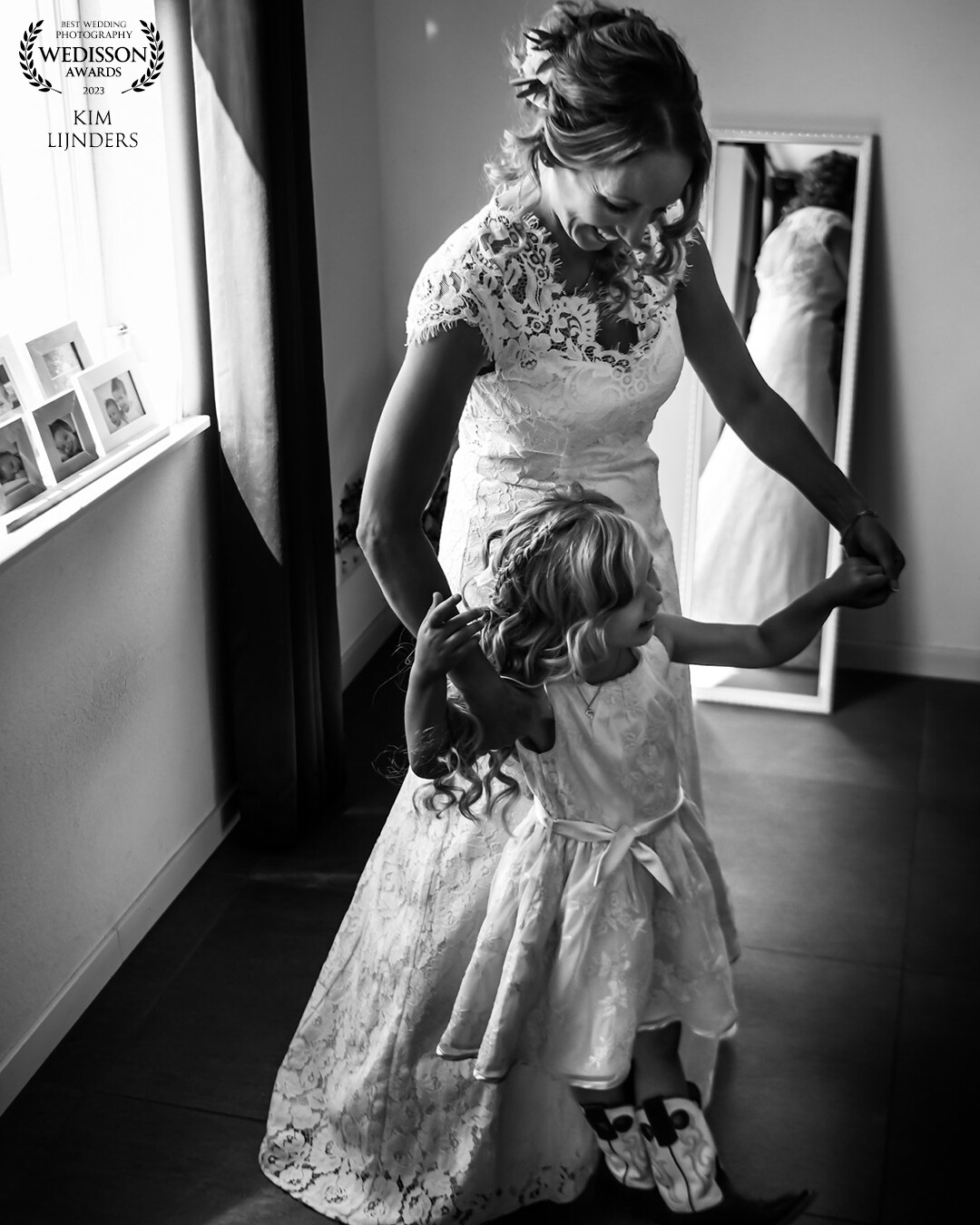 Bride and her little bridesmaid, dancing in the room, after getting dressed and watch themselves in the mirror how beautiful they are.<br />
How lovely are they together?