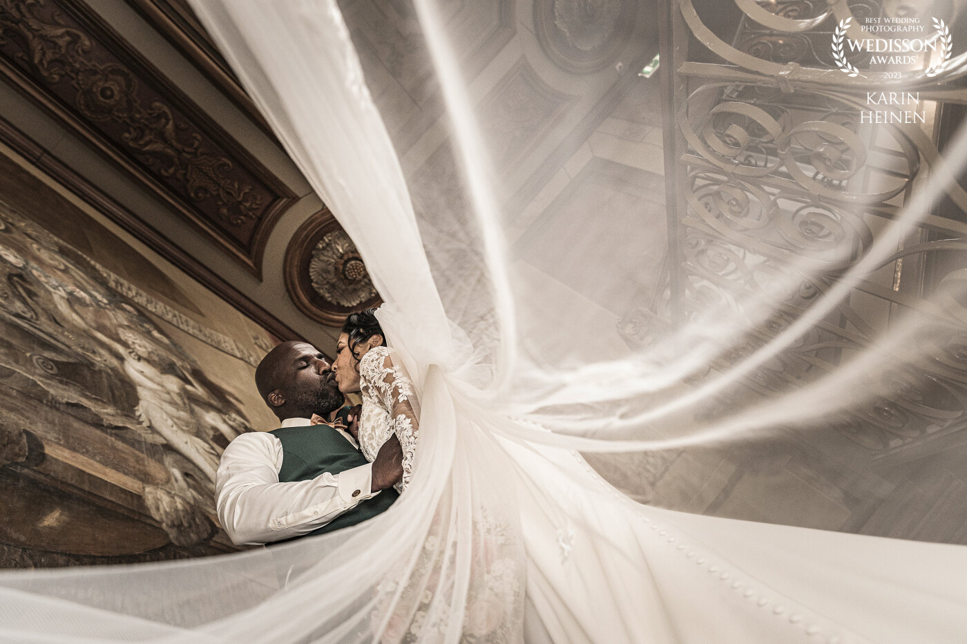 O&V celebrated their wedding at one of the most unique and exclusive wedding venues in the Netherlands. The grand hallway provides a classic stairway and looking up from the ground level the majestic painting of the ceiling is overwhelming. This upward view alongside the veil and the intense moment of the wedding couple resulted in this shot.