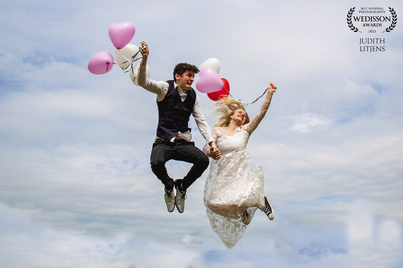 I love it when a bridal couple wants nice happy photos. A bright blue sky, a few helium balloons and high jumps make this photo.