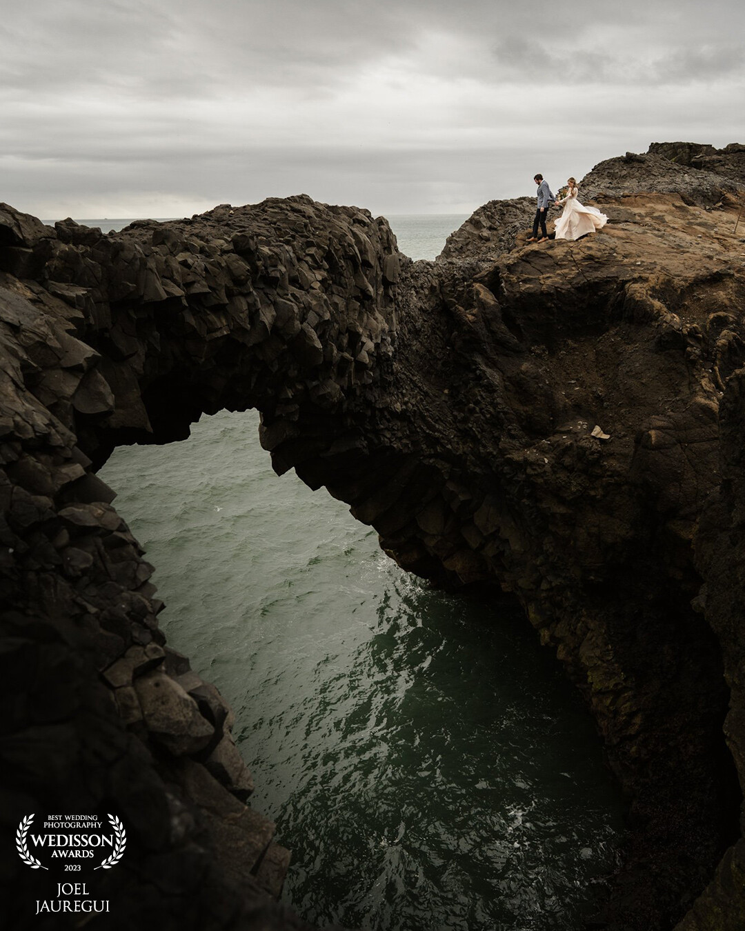 This was one of my favorite Adventure Elopements in Iceland. I was in Iceland filming and photographing some promotional work for my friend, Tyler and a few days prior he had some elopements that I second shot for him. This was shot near Black Sand Beach and as you can see if you angle yourself right, you get this awesome view of the natural stone arch.