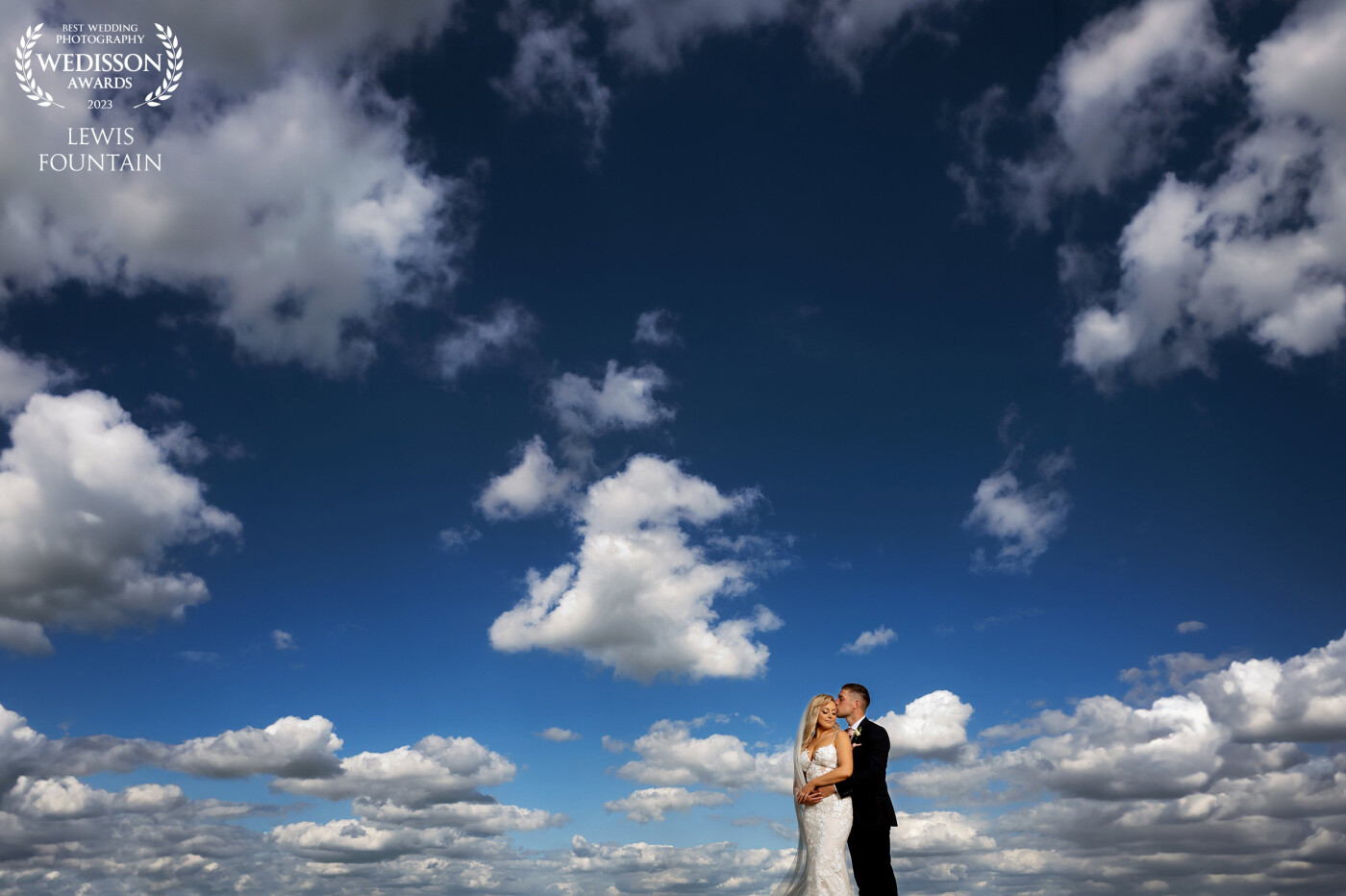 The perspective of the clouds to the bride & groom was what we loved when framing this shot. <br />
<br />
One of the couple’s favourites, and now one of ours