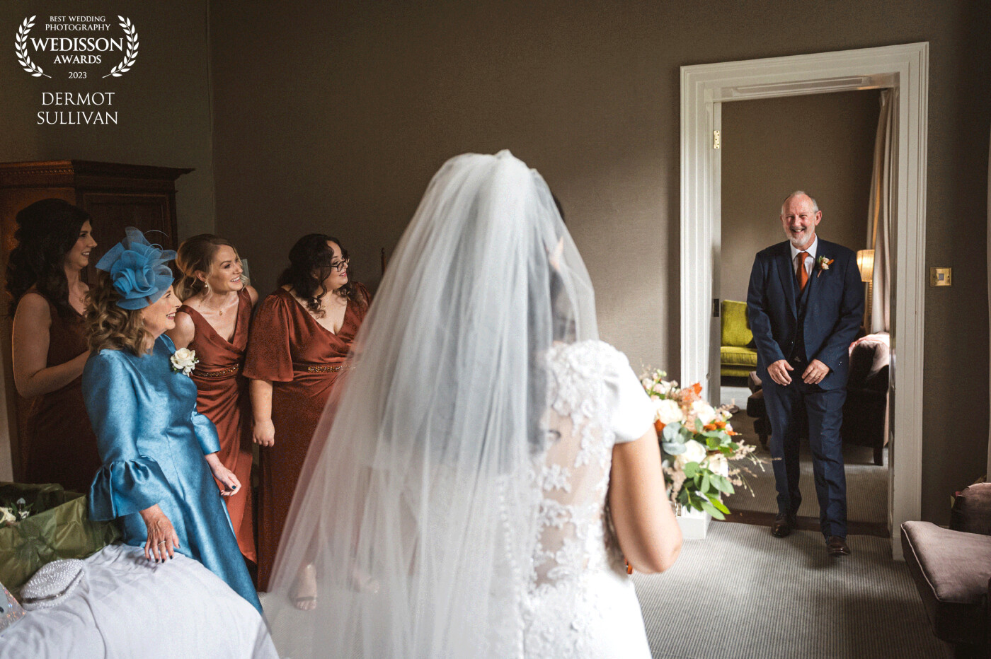 This is the classic wedding day moment when the brides father sees her in her dress for the first time. For this photograph, I positioned the brides mother and bridesmaids off the the side so that I could get their reactions too.