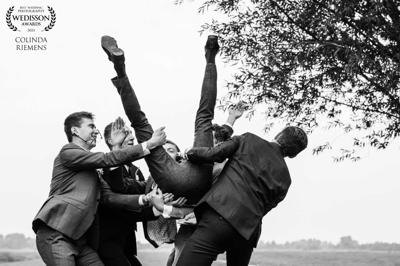It is a great habit for groomsmen to lift the groom up. While the groom was falling back into their arms, the glasses of one of them were hit by the groom's hand so they didn't stay properly on where they belong!