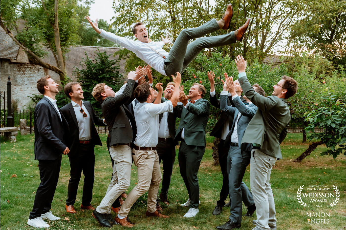 The groomsmen wanted a fun photo with the groom. So I told them it would be fun if they threw him in the air. I clicked at the exact right time. So happy with the result!
