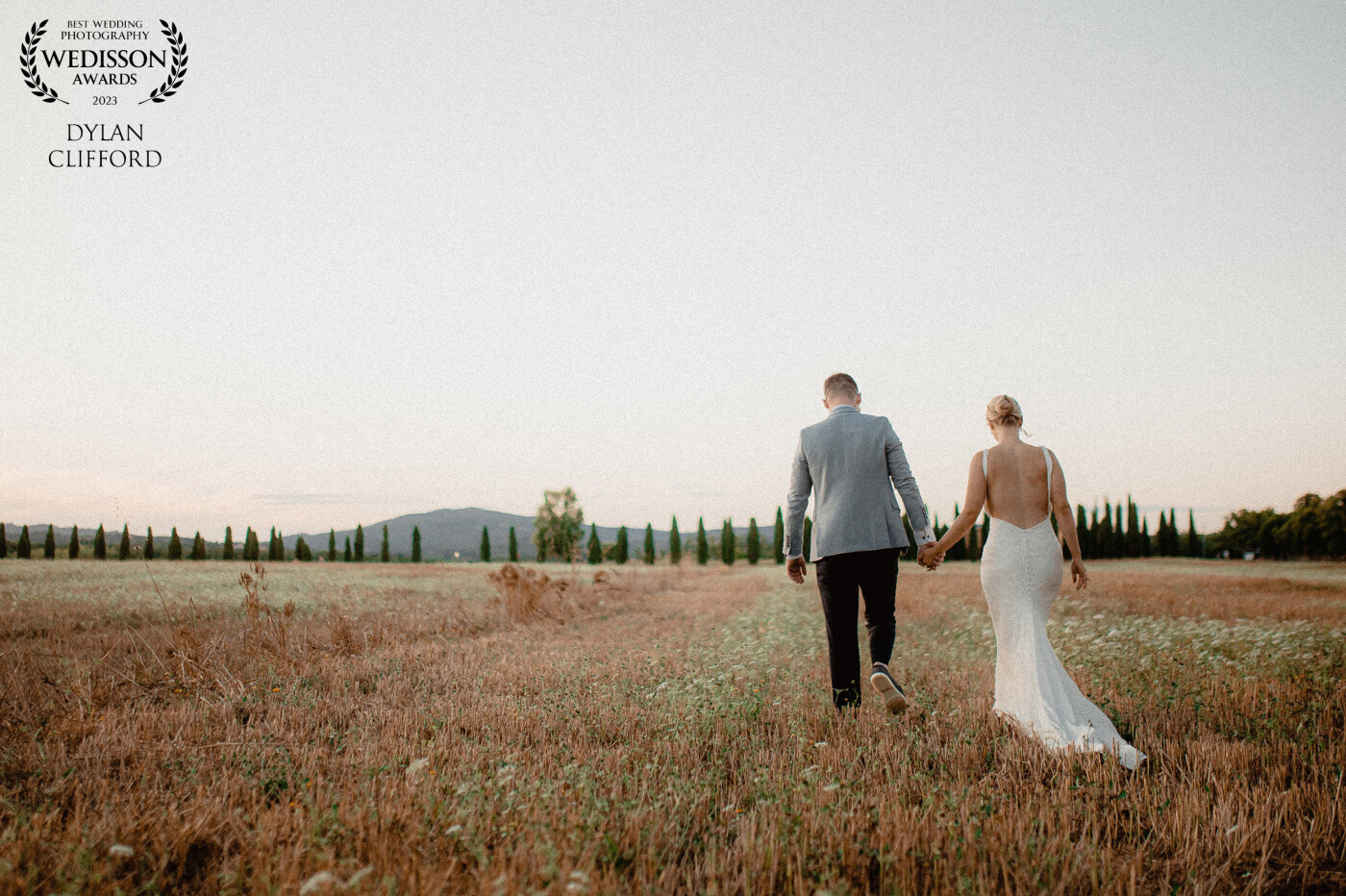Jenny and Dean as newly weds walking the fields of Tuscany.
