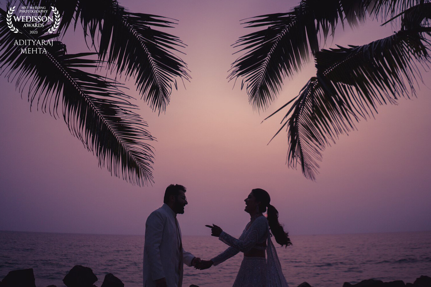 Drasti & Karan had a magical wedding set against the backwaters in Kerala, India. <br />
<br />
Their chemistry is unparalleled, they cannot hold still for more than about 3 milliseconds, and so giving them any kid of poses was an impossible task. The sun had already set, and there is this brief 60 second window in between sunset and blue hour, around the coastal regions of South India, when the sky transitions from orange to a pinkish-purple hue, before turning to blue. It doesn't happen everyday, it is rare, but when it does, it looks magnificent!<br />
<br />
We had our frame ready, as soon as the sky turned the right hue, we asked them to step into frame and to just be themselves. This was just before their sangeet performance night, and so practicing their dance moves was all they could think of! This image here, is a BTS image of them practicing their first dance, moments before they get on stage, against a backdrop that probably only occurs one in a hundred times.
