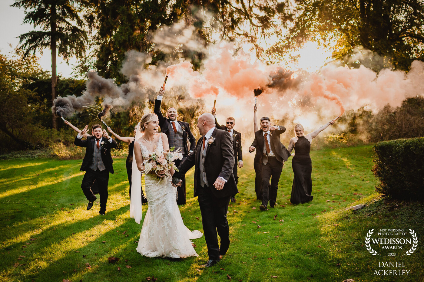 The golden hour hit just right as I was wrapping up my portrait session with Megan & Daniel, so their wedding party grabbed some smoke grenades and it made for a really fantastic back-lit scene!
