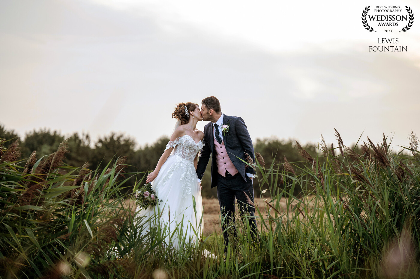 We got so many beautiful images at Klea & Daniels Old Hall Ely wedding, and we would normally include the lake in these type of shots, but the couple kissing through the reads seemed to warrant the focus to be on them.