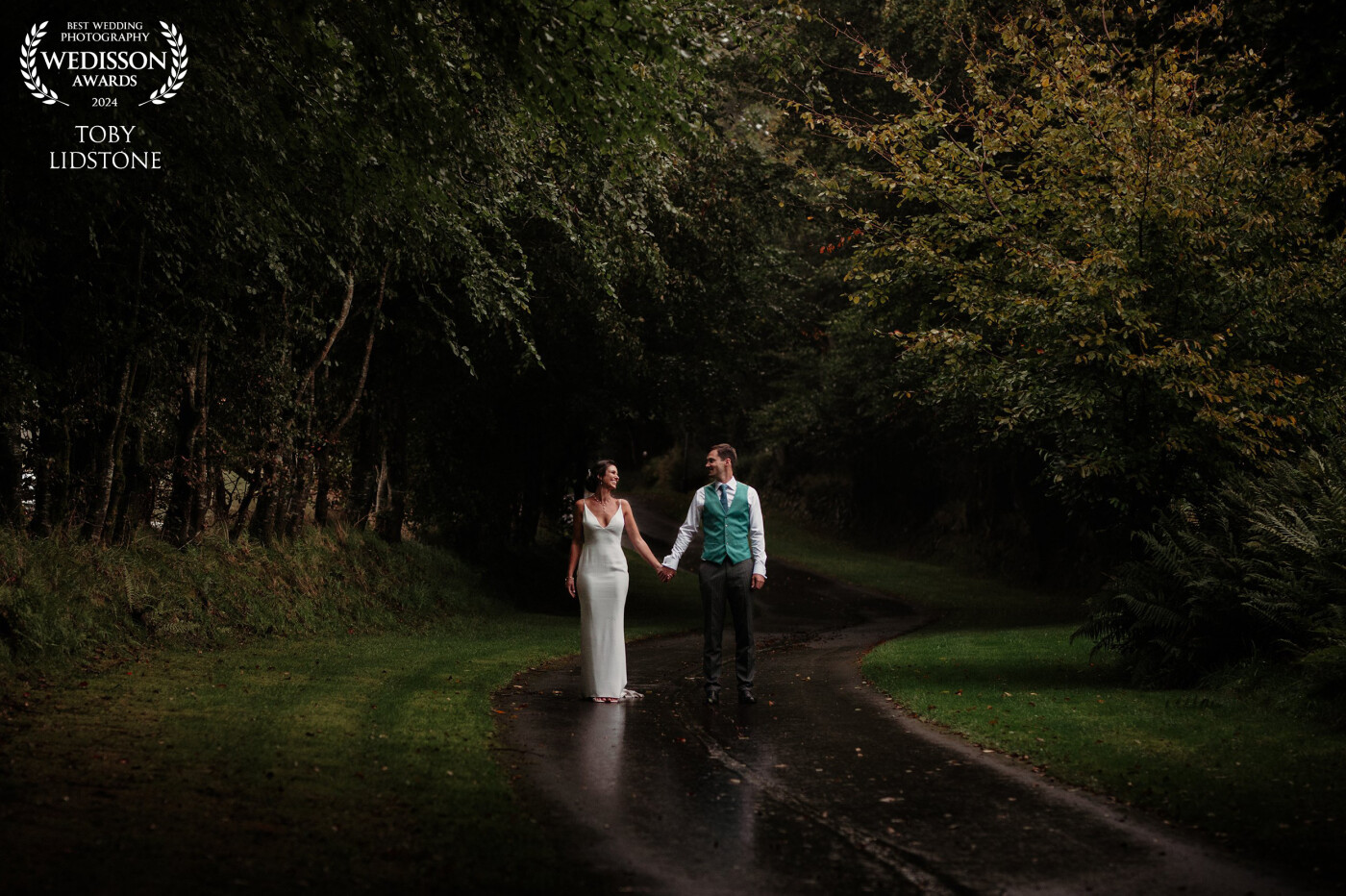 I just love creating scenes with big contrast in light. It rained all day for this wedding, but  these two were stars and embraced the weather for some outdoor shots, I like the fact the road is wet and creating a reflection :)