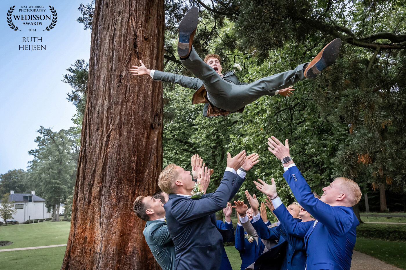 Capturing the thrill of the moment: the groom, propelled skyward by the exuberance of his ten friends, extends his limbs and lifts his head. A blend of pure joy and the anticipation of the aerial adventure etched across his face. <br />
The photo symbolizes the groom's leap into the exciting path of marriage.