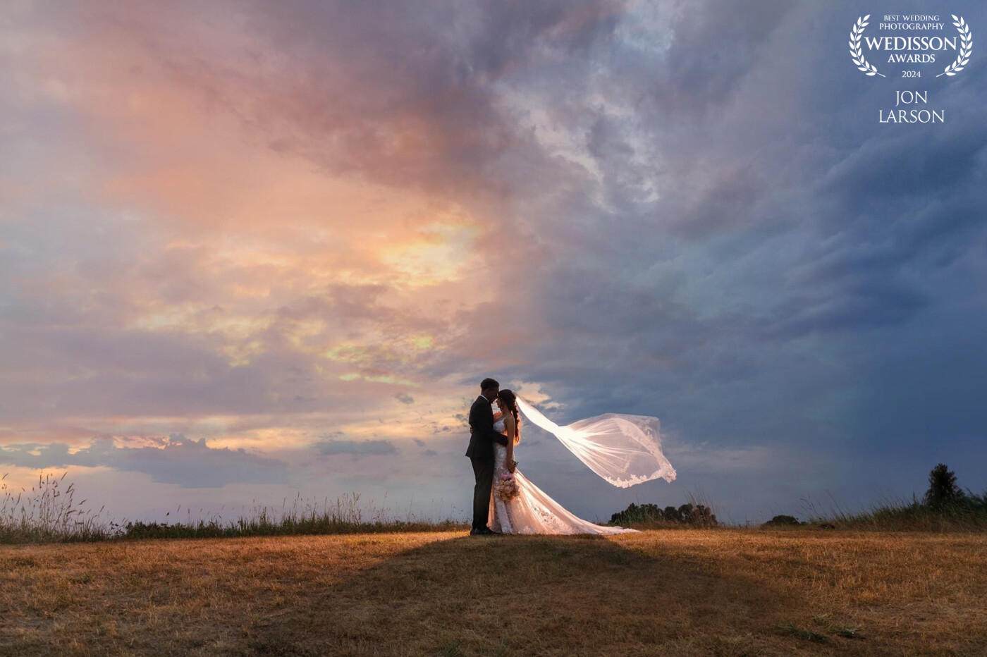 The bride and groom shared a very private moment a top of a hill just as a storm was swallowing up the sunset causing a unique coloring in the sky!
