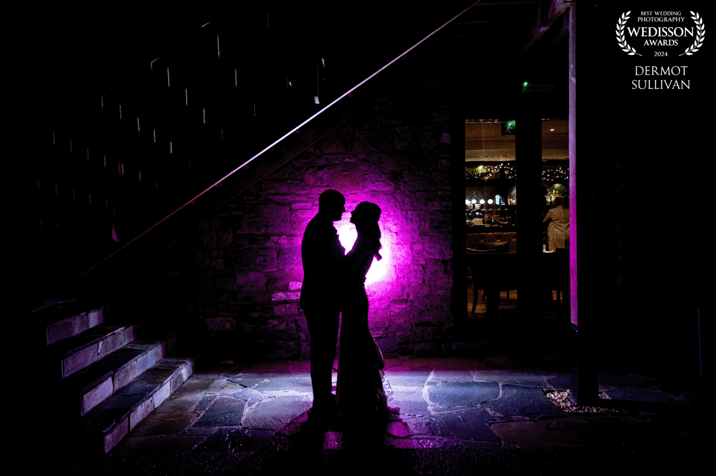 We had about 10 minutes before the couple went in for dinner and I found a couple of places around the venue that would work for a night shot. Luckily it was December in Ireland so it dark at 4.30. I put a flash with a Magmod gel & grid behind my couple and hey presto!