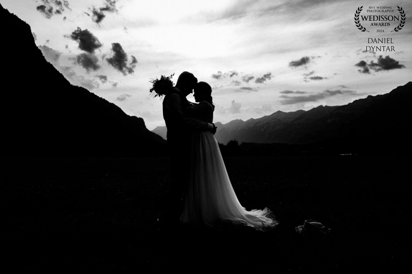One of my favorite weddings. It was in Meiringen near the army airport. I love to have mountains in the background. This photo was taken after sunset and i love it. Awesome couple beautiful cloudy sky and mountains.