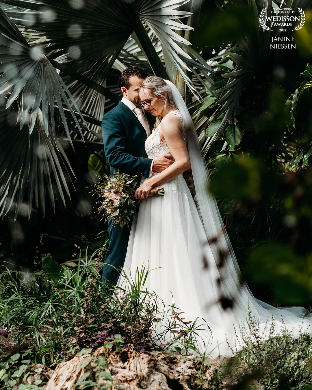 In the midst of lush greenery, their love shone bright. Standing close in the bushes, they captured a moment of pure romance that will last a lifetime.