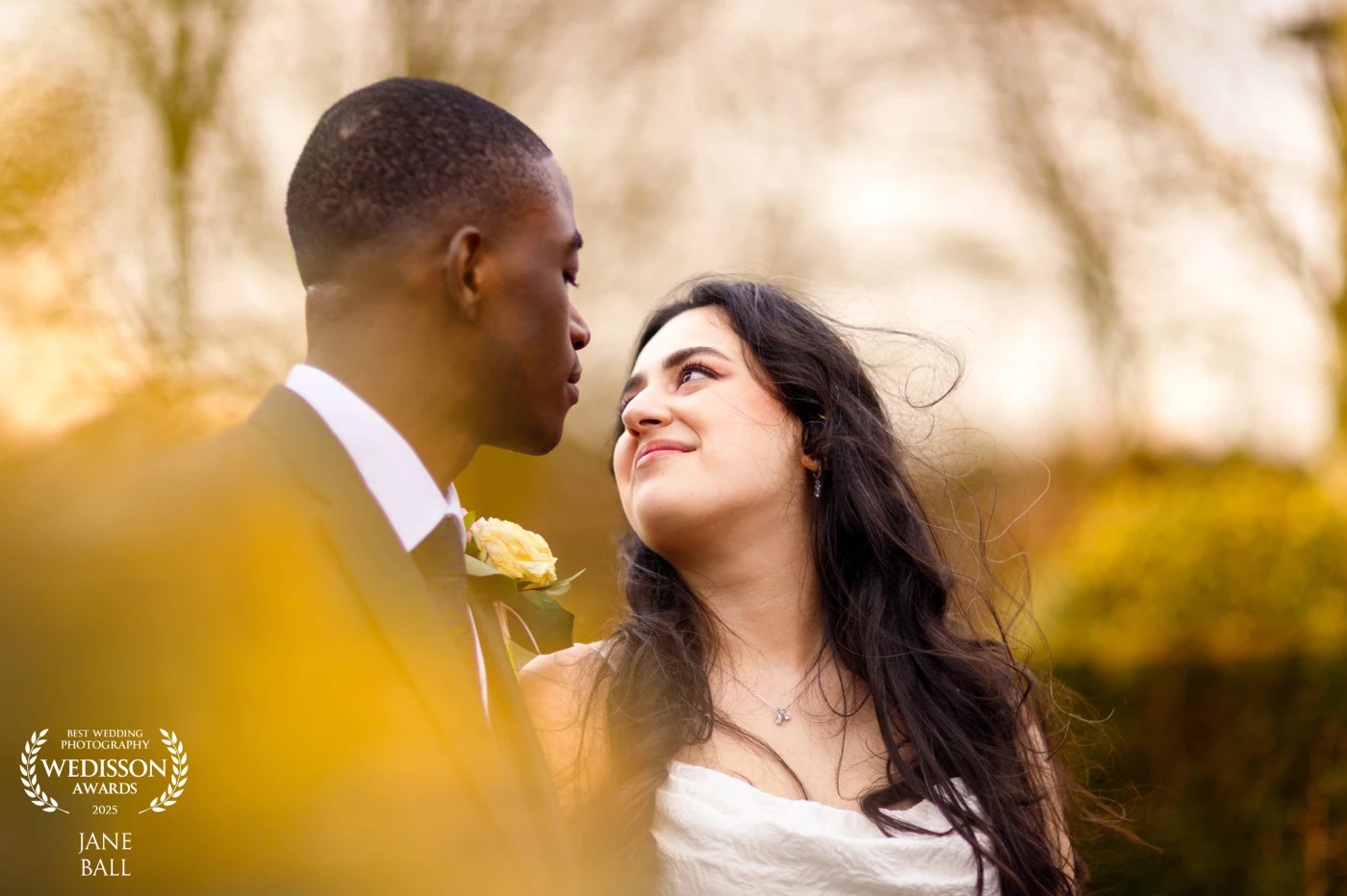 This photo was taken on a dull and blustery day although you wouldn't know it looking at the vibrant colour in this shot. I always like to find some kind of foreground foliage to shoot through to create a dreamy bokeh and by positioning myself behind the shrubbery at the venue I was able to create this image of my couple as they stole a few moments away from the hustle and bustle of the day just for themselves.