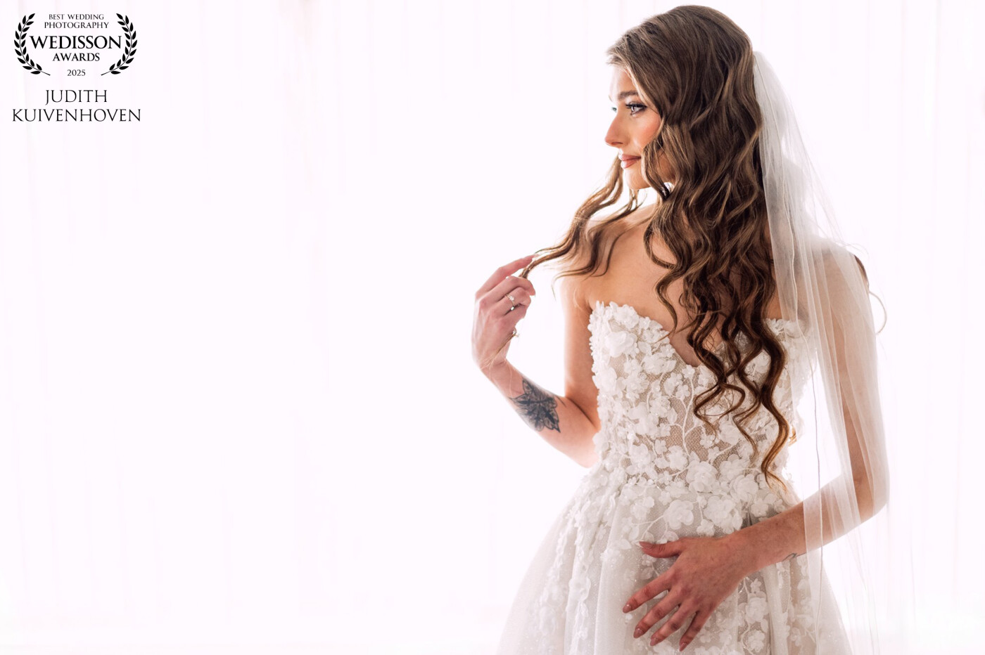Freshly ready for her big day, the bride stands in beautiful light โ quiet, radiant, and full of anticipation.