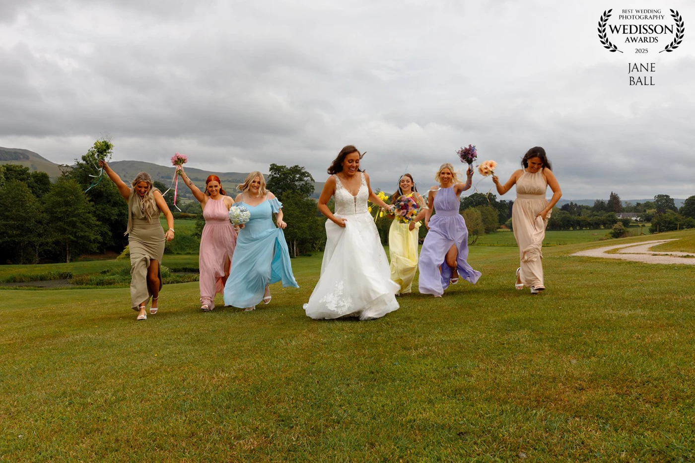 This was such a fun shot to get. All the girls were really up for a bit of a laugh so I sat on the grass and let them run towards me keeping my finger firmly on the shutter to shoot through the moment. The resulting image was one that the bride really loved.