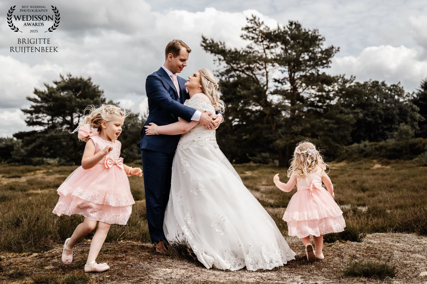 Their own daughters as flower girls. Running, laughing, just being themselves. This moment says it all.