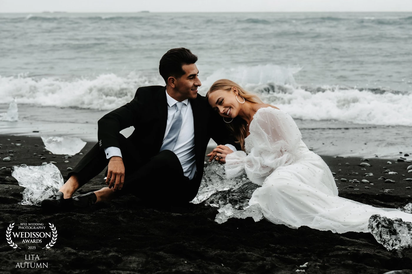 “Love is not just looking at each other, but looking together in the same direction.” – Antoine de Saint-Exupéry <br />
<br />
In the heart of Iceland, where the land meets the sea, lies a place of breathtaking beauty known as Diamond Beach. This unique location, with its shimmering icebergs scattered across black sands, offers an ethereal setting that captivates the soul. Whether it's a spontaneous laugh shared as the wind tousles their hair or a quiet chuckle at a shared joke, the moments at Diamond Beach are filled with genuine happiness.